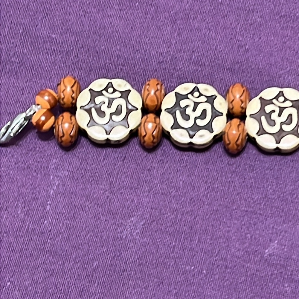 Bracelet of plastic type material with Ohm Image as in pic.